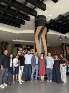 A large group of people indoors smiling
